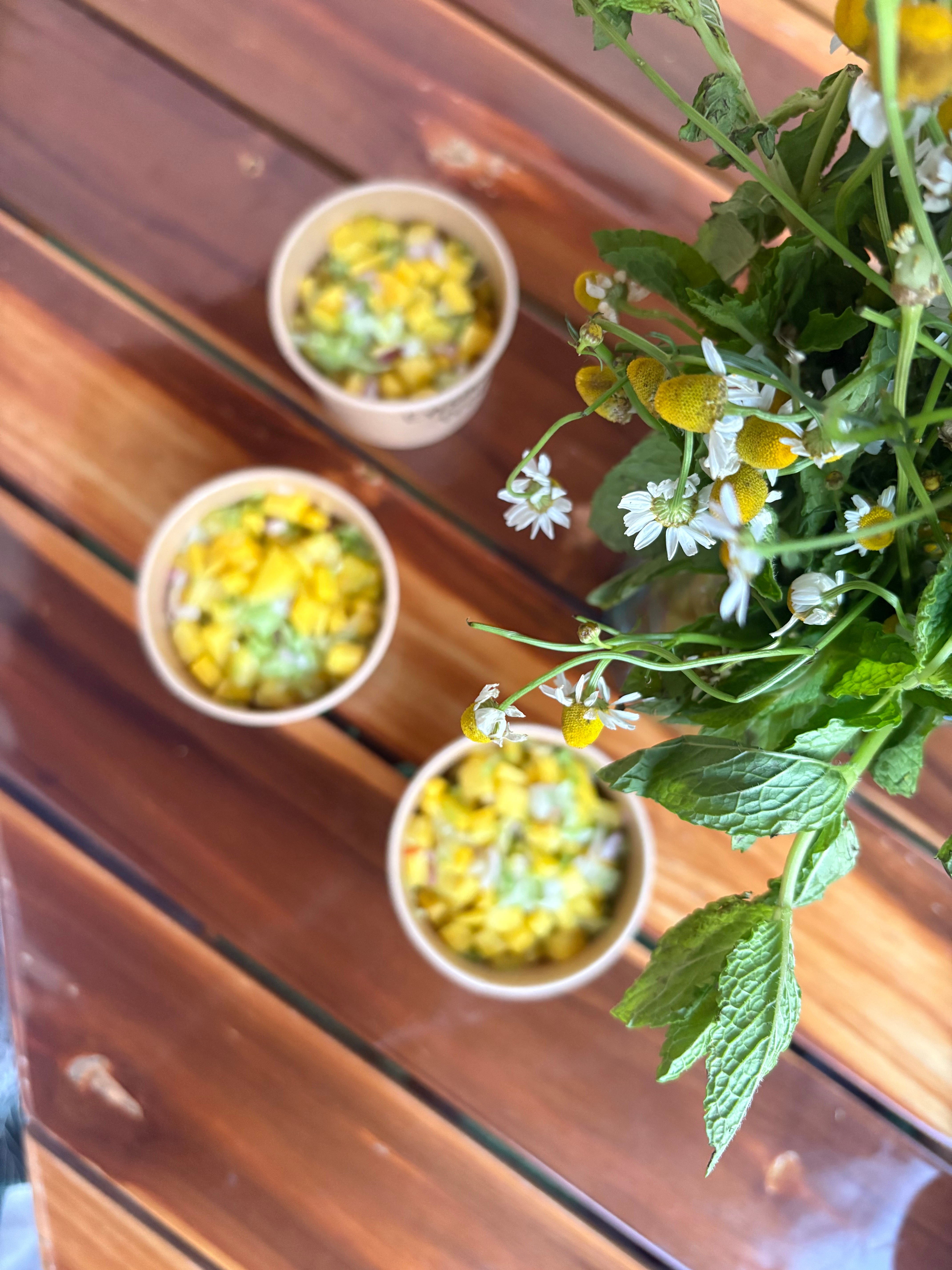 Decorative corn cups arranged with flowers on a table